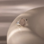 Organic Fingerprint Signet Ring: This handcrafted silver ring features a unique fingerprint design, displayed on a smooth beige surface with soft lighting for an elegant, personalized keepsake.
