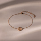 Dainty Organic Fingerprint Bracelet in Rose Gold with a round textured charm, shown on a neutral background with soft shadows—an ideal personalized gift.