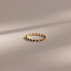 The Dainty Marquise Sapphire Ring showcases small dark sapphires in a marquise pattern, offering a touch of Art Deco elegance.