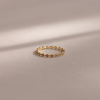 The Dainty Marquise Alexandrite Ring, featuring a delicate marquise-shaped design in gold, is displayed on a soft, neutral background.