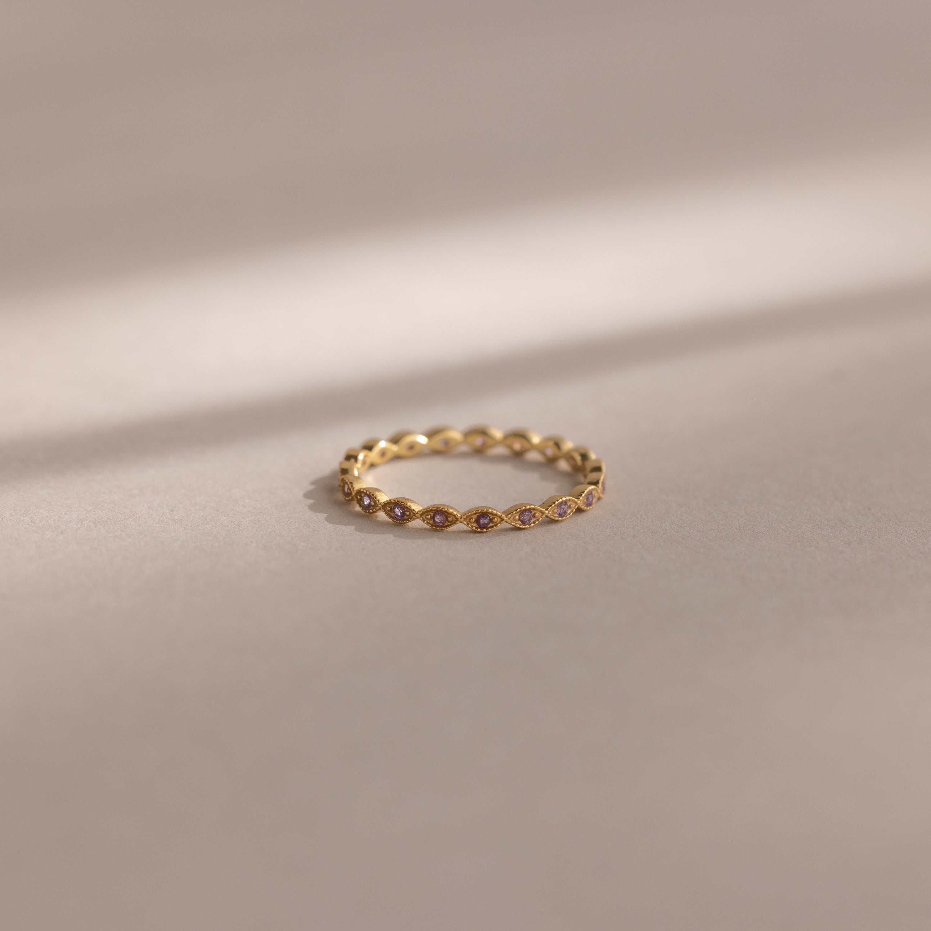 The Dainty Marquise Alexandrite Ring, featuring a delicate marquise-shaped design in gold, is displayed on a soft, neutral background.