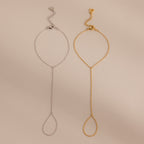 Two Dainty Hand Chain Bracelets, one in silver and one in gold, are displayed side by side on a beige background—perfect for anyone who loves delicate jewelry.