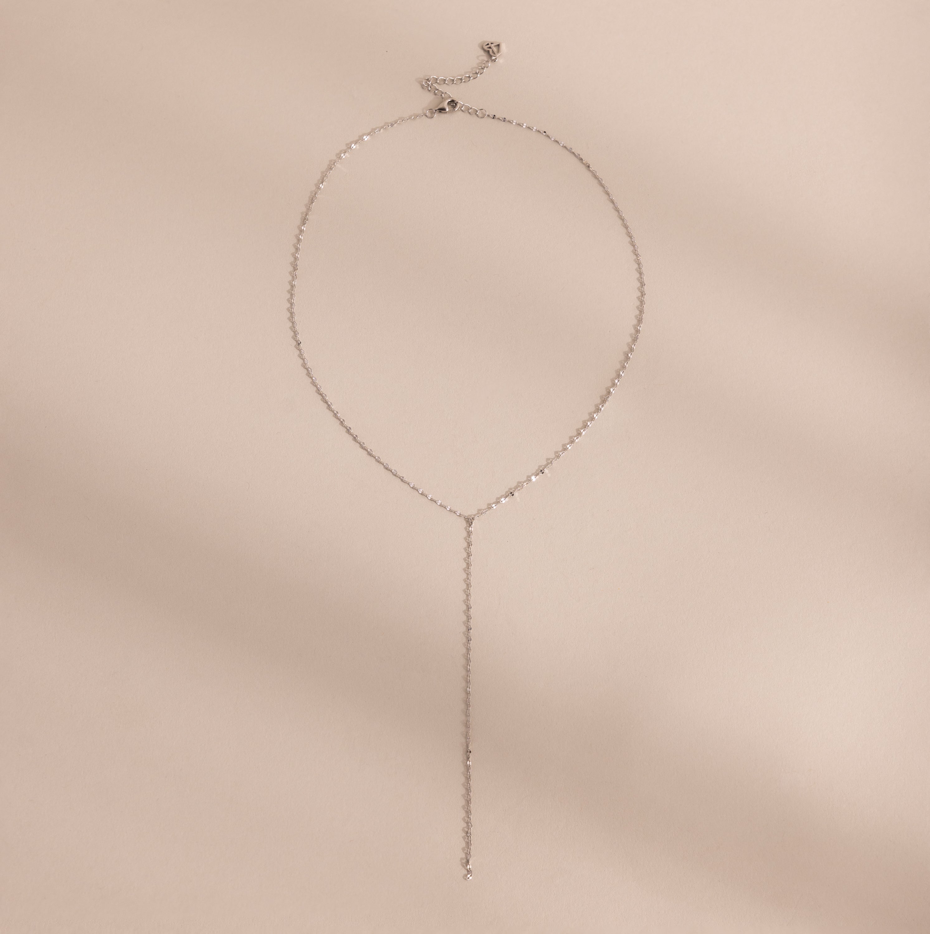 Silver mirror chain lariat necklace displayed on a neutral background.