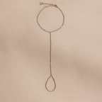 Sterling silver Curb Hand Chain Bracelet with the ring chain displayed on a neutral surface.