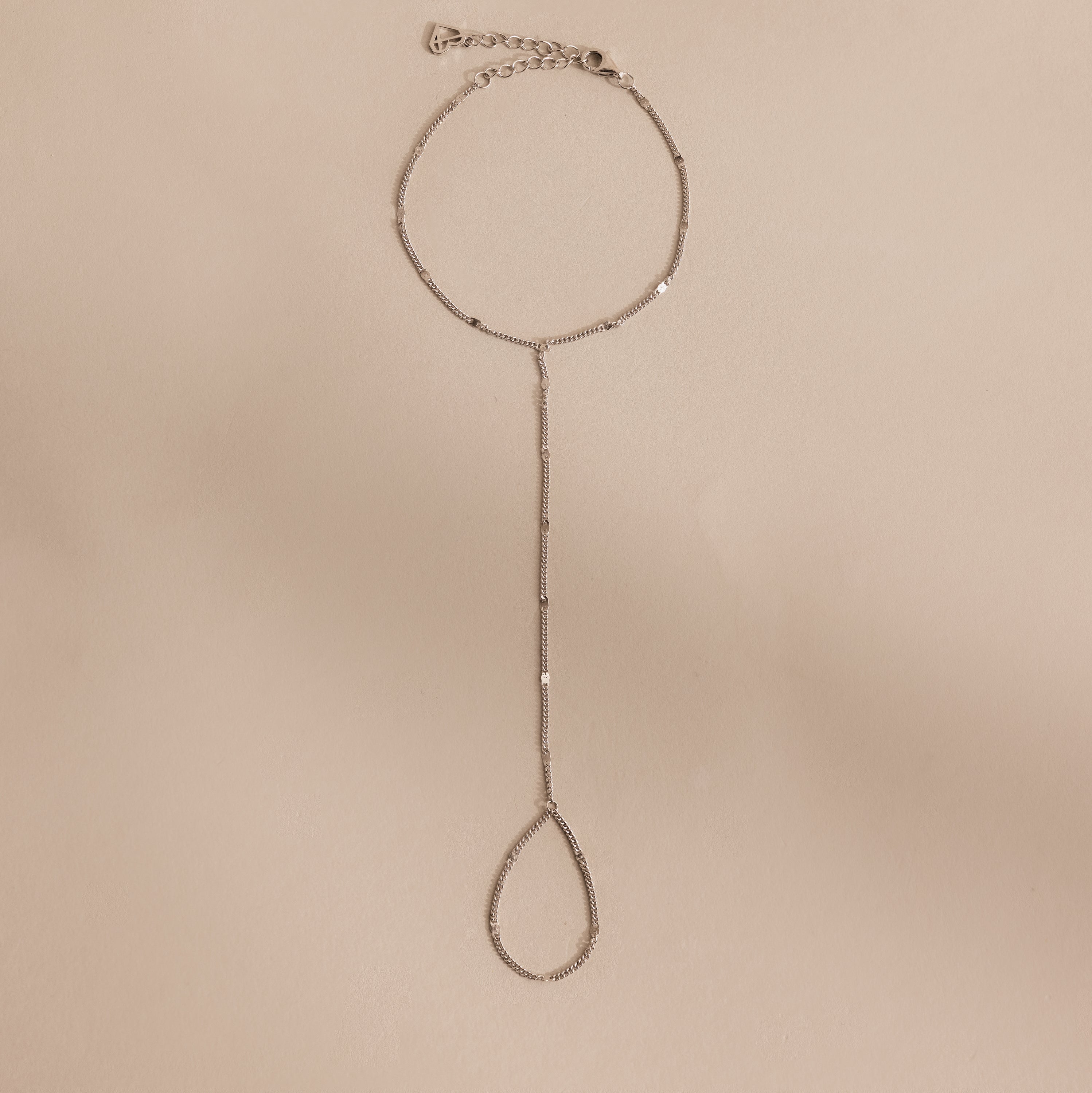 Sterling silver Curb Hand Chain Bracelet with the ring chain displayed on a neutral surface.