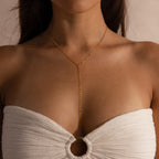 A woman wears the Mirror Chain Lariat Necklace with a white textured strapless top featuring a ring detail.