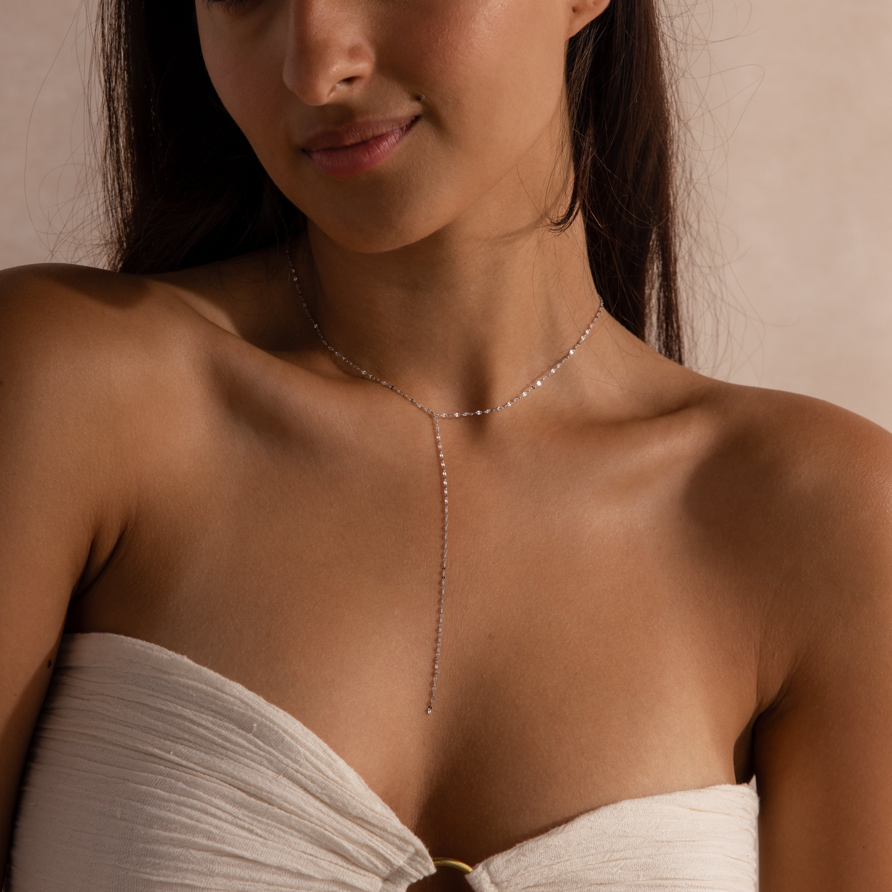 Model wearing a sterling silver dainty mirror chain lariat necklace.