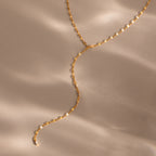 Gold dainty Sparkling Diamond Lariat Necklace with a delicate mirror chain design and two CZ diamond stones, displayed on a neutral surface.