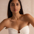 Far-view of model wearing a gold dainty Sparkling Diamond Lariat Necklace, layered with a marquise peridot birthstone necklace.