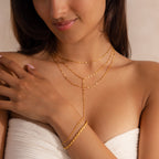 Model wearing a gold dainty Sparkling Layered Lariat Necklace, featuring 3 layers of mirror chain necklaces in varying lengths, styled with 2 gold bracelets.