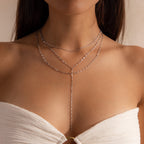 Model wearing a silver dainty Sparkling Layered Lariat Necklace, featuring 3 layers of mirror chain necklaces in varying lengths.