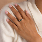 A hand wearing the agate statement ring with the silver band clearly visible against a soft cream sweater. 