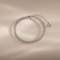 The Fishtail Chain Bracelet in Silver features an elegant leaf pattern with adjustable interwoven links and a heart-shaped charm—perfect as a stylish gift for any occasion.