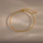 Dune Beaded Bracelet: gold polished beads with adjustable clasp and heart charm, ideal for layered looks—shown on a neutral background with soft shadows.