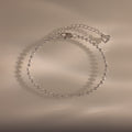 Dune Beaded Bracelet in Silver features polished silver beads, a heart charm, and an adjustable chain, displayed on a neutral background.