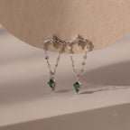 Agate Star Chain Earrings in Sterling Silver feature star-shaped studs, chain drops, and green agate gemstone pendants for a celestial look that dazzles against any neutral backdrop.