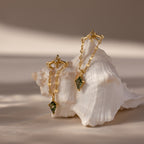 Agate Star Chain Earrings in 18K Gold with green agate gemstone drops, displayed on a white seashell against a neutral background.