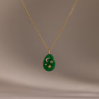 The Celestial Jade Pendant Necklace features a gold chain and green teardrop pendant with crescent moon, star, and diamond accents.