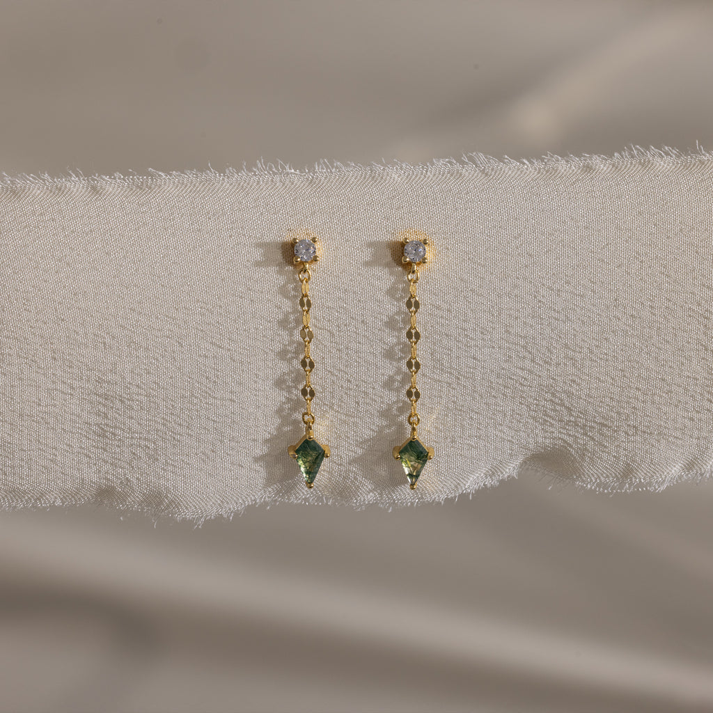Agate Diamond Dangle Earrings in 18K Gold, featuring faceted agate stone pendants, displayed on a textured white fabric background.