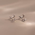Pair of silver star drop flatback studs shown on a neutral background.