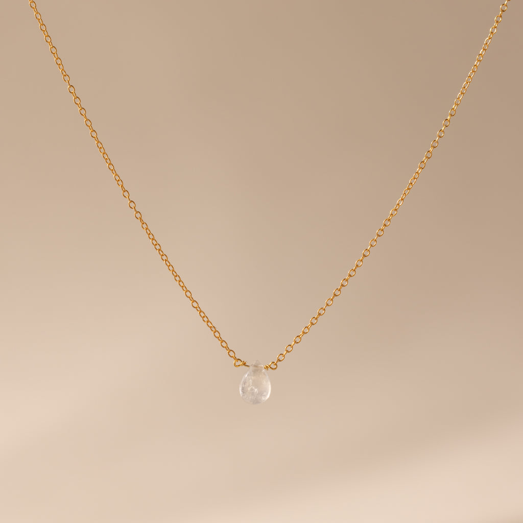 Teardrop Moonstone Necklace in 18K Gold, featuring a gold chain and a single moonstone pendant, elegantly displayed on a beige background.
