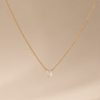 Teardrop Moonstone Necklace in 18K Gold, featuring a gold chain and a single moonstone pendant, elegantly displayed on a beige background.