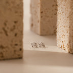 Moonstone Orbit Studs in Sterling Silver, featuring clear gemstones between two textured beige stone blocks—perfect for those who appreciate the timeless elegance of diamond accent earrings.