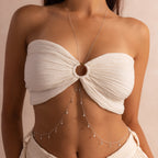 Close-up of model wearing the sterling silver version of the body chain, featuring dangling bezel-set diamonds on multiple dainty chains.