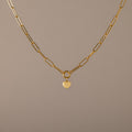 Paperclip Heart Charm Necklace in 18K Gold with elongated links and a delicate heart pendant, displayed on a neutral background—the perfect accessory for subtle elegance with any outfit.