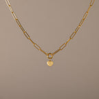 Paperclip Heart Charm Necklace in 18K Gold with elongated links and a delicate heart pendant, displayed on a neutral background—the perfect accessory for subtle elegance with any outfit.