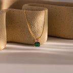 Flatlay of our Emerald Bloom Necklace with Pink Tourmaline and Emerald Gemstones