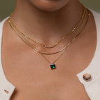 Model wearing our Emerald Bloom Necklace, styled with our Josephine Necklace and our Herringbone Necklace