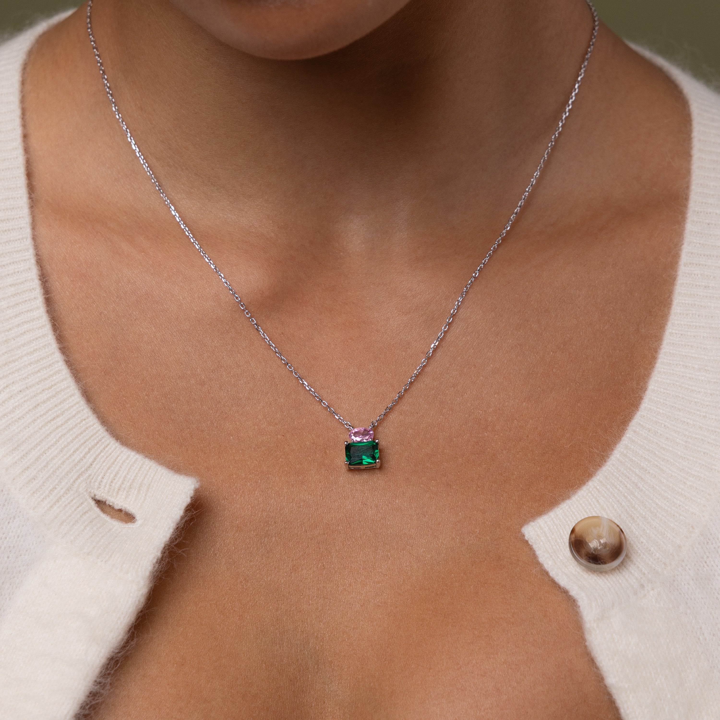 Close up of model wearing our Emerald Bloom Necklace with Pink Tourmaline and Emerald gemstones