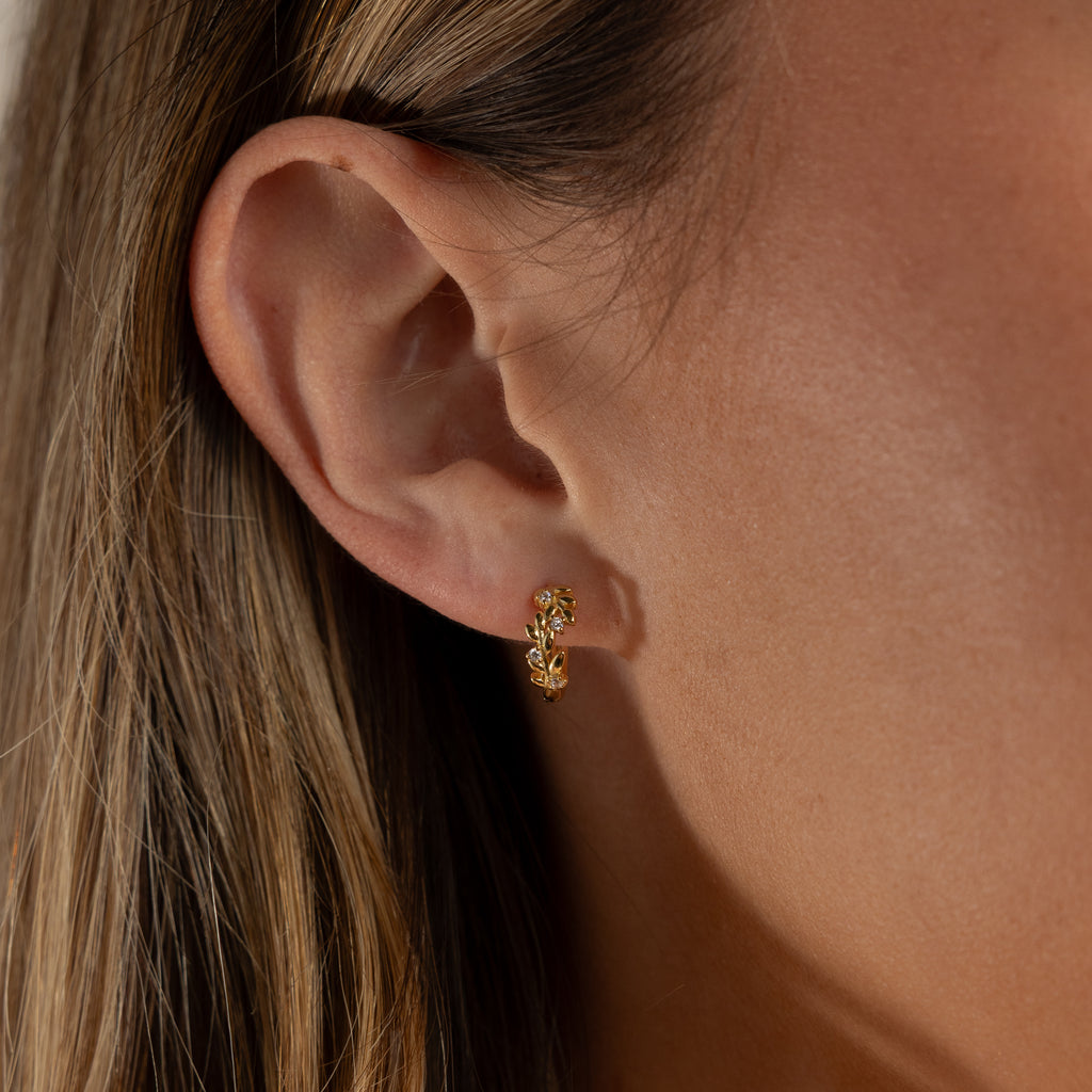 Close up of model wearing our Diamond Leaf Hoops in Gold