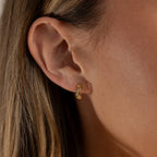 Close up of model wearing our Diamond Leaf Hoops in Gold