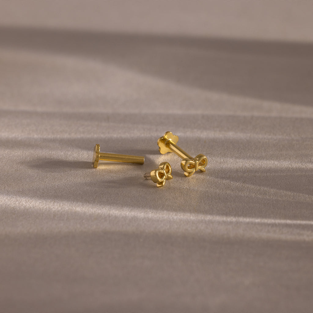 Flatlay of our Tiny Bow Flatback Studs in Gold, with the flatback post separated