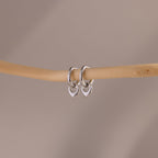Flatlay of our Tiny Teardrop Huggies in White Gold