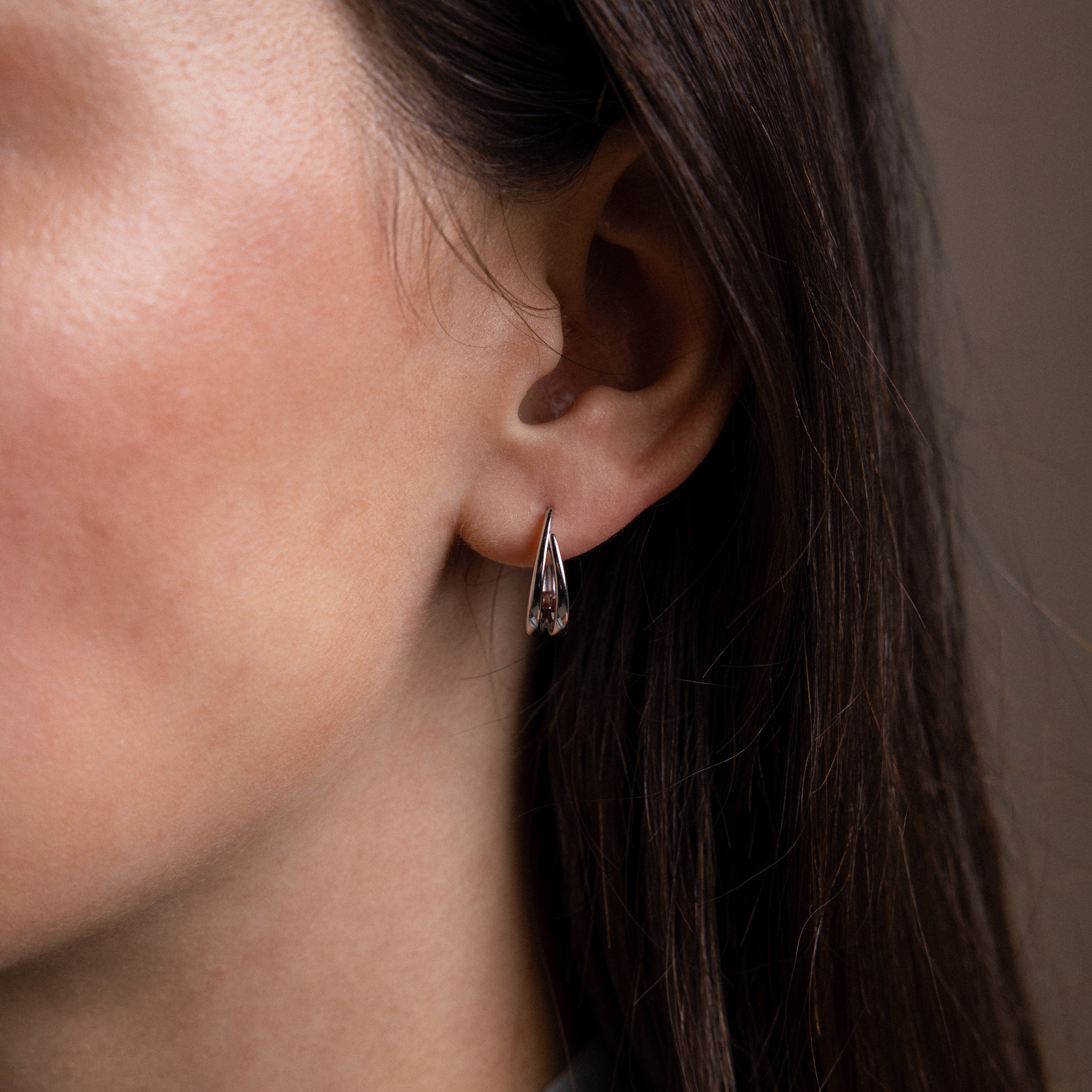 Close up of a model wearing our Oval Duo Hoops in Sterling Silver