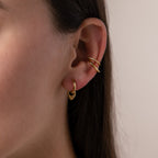 Close up of a model wearing our Tiny Teardrop Huggies, styled with our Lydia Duo Cuffs