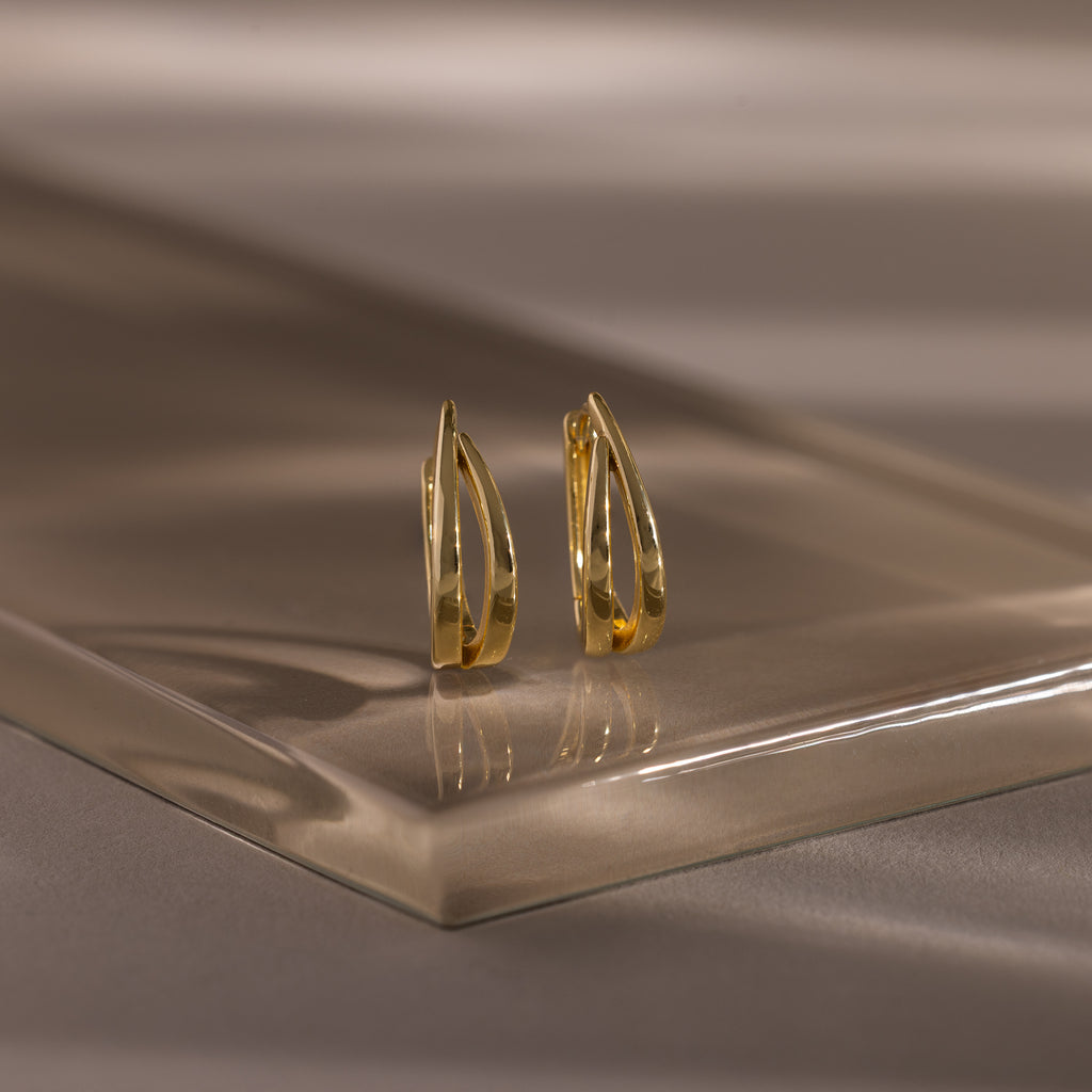 Close up flatlay image of our Oval Duo Hoops in Gold