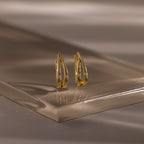 Close up flatlay image of our Oval Duo Hoops in Gold