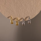Flatlay of our Oval Duo Hoops in Gold and Silver
