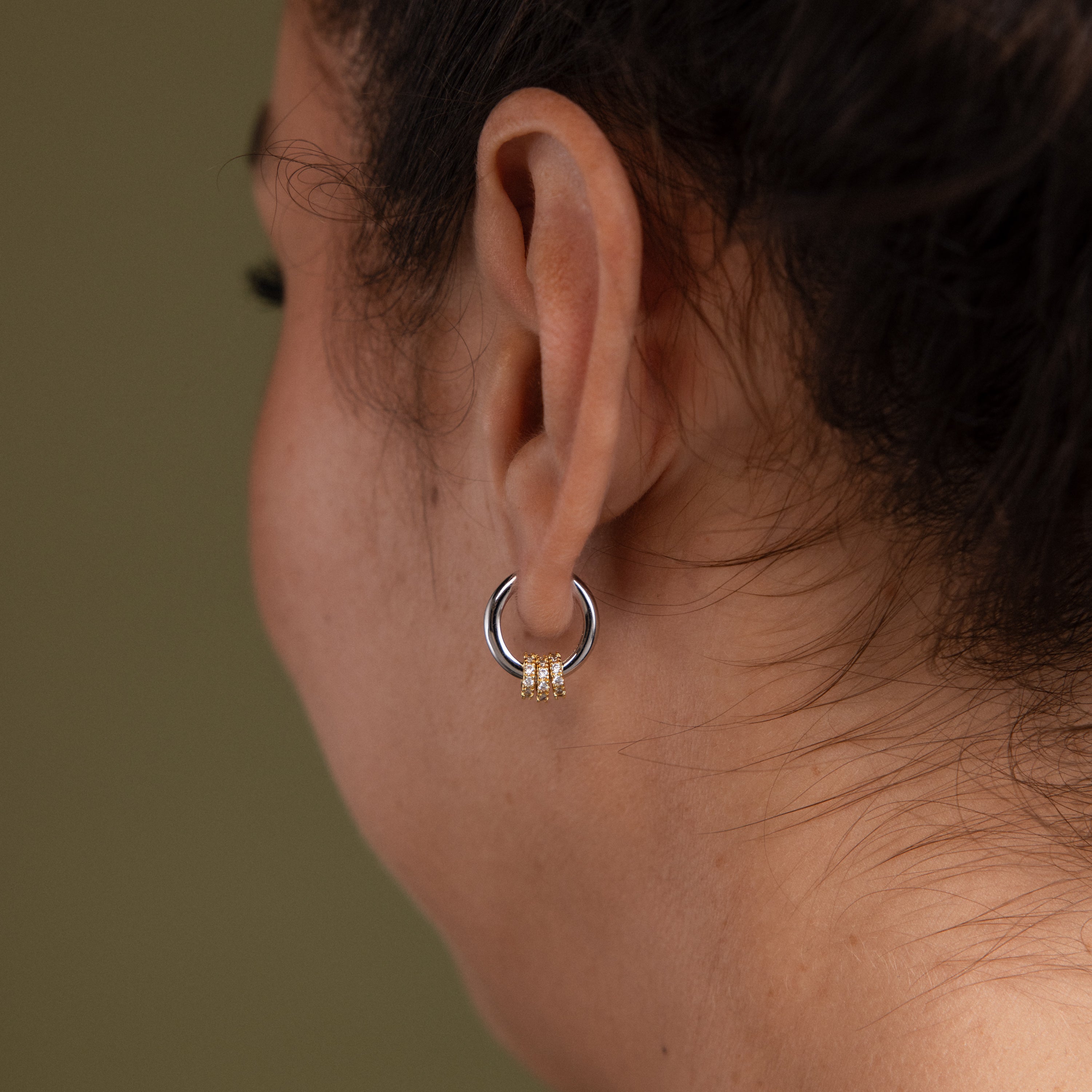 Close-up of a model wearing our Mixed Metal Pave Hoops in White Gold