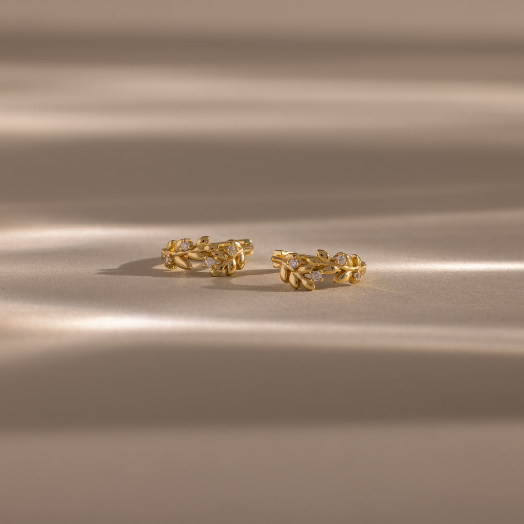 Flatlay image of our Diamond Leaf Hoops in Gold