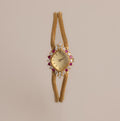 Our Duo Chain Ruby Timepiece watch on a beige background
