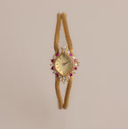 Our Duo Chain Ruby Timepiece watch on a beige background