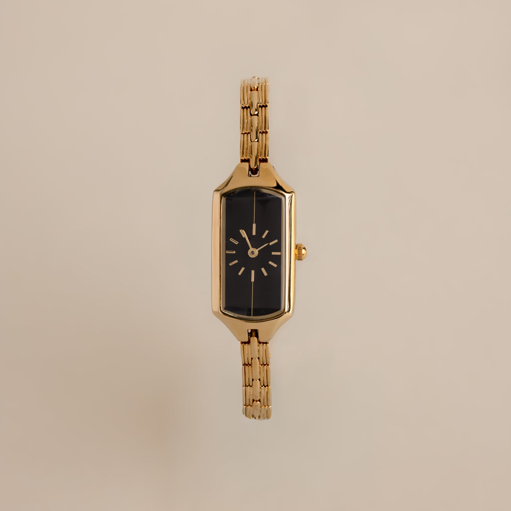 Close up of our Midnight Link Timepiece watch against a beige background