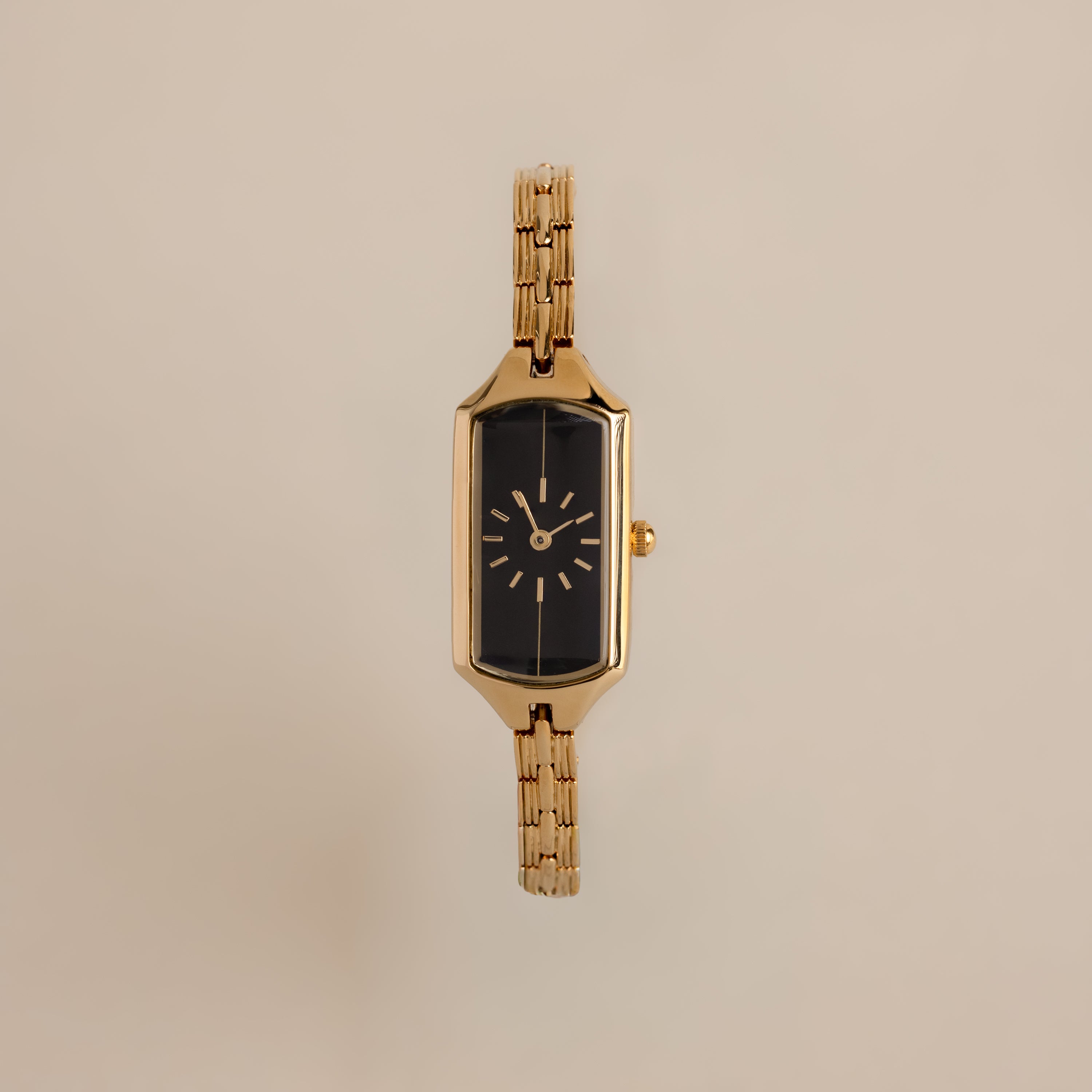 Close up of our Midnight Link Timepiece watch against a beige background