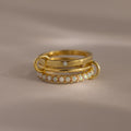 The Triple Linked Opal Ring Set features three stacked gold rings—one with delicate pearl-like beads and another with a sparkling white opal—for an elegant, layered look.