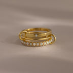 The Triple Linked Opal Ring Set features three stacked gold rings—one with delicate pearl-like beads and another with a sparkling white opal—for an elegant, layered look.